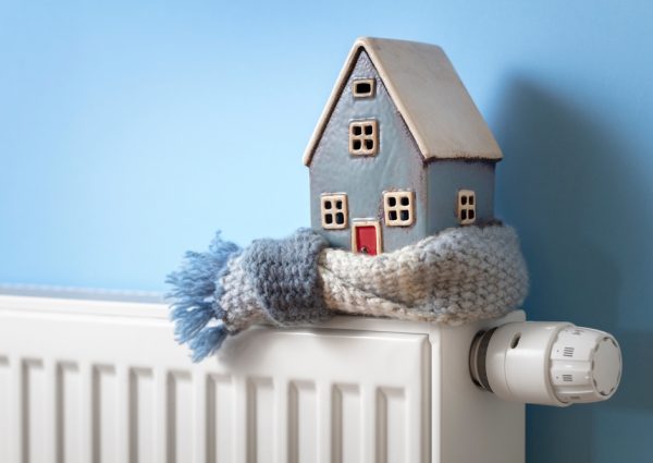 House,Model,Wrapped,In,Scarf,On,Radiator,Home,Winter,Heating